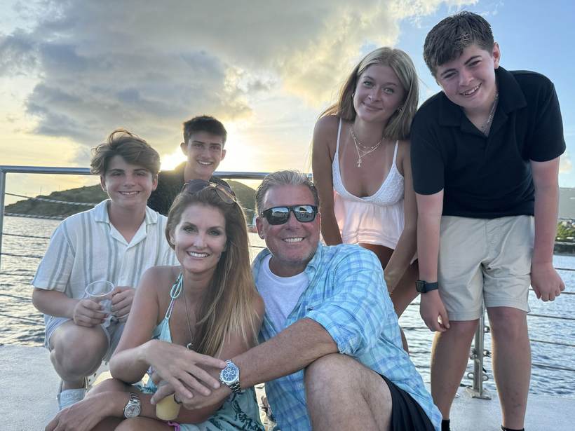 Kellie Lightbourn with her husband and children at sunset on a boat