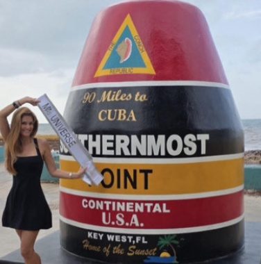 Kellie Lightbourn in her Mrs. Universe sash at the Southernmost Point buoy in Key West