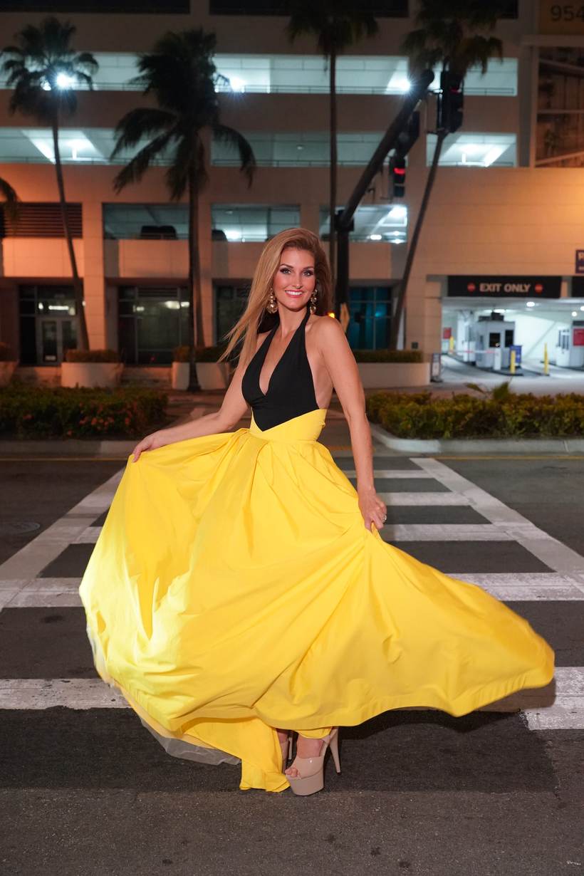Kellie Lightbourn, Mrs. Universe® 2026, in a yellow ball gown in the city at night